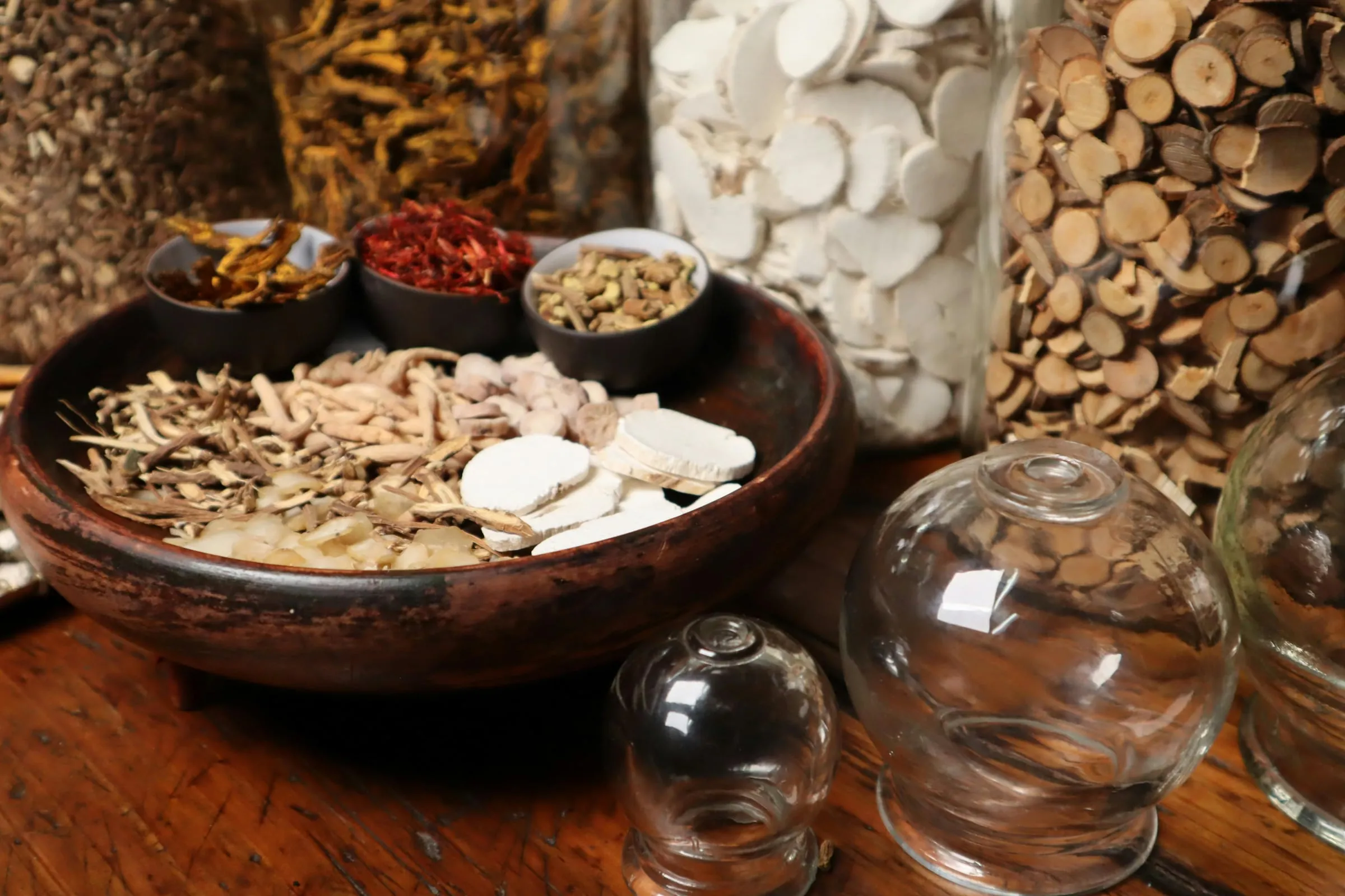 Dried tonic herbs and berries in small bowls